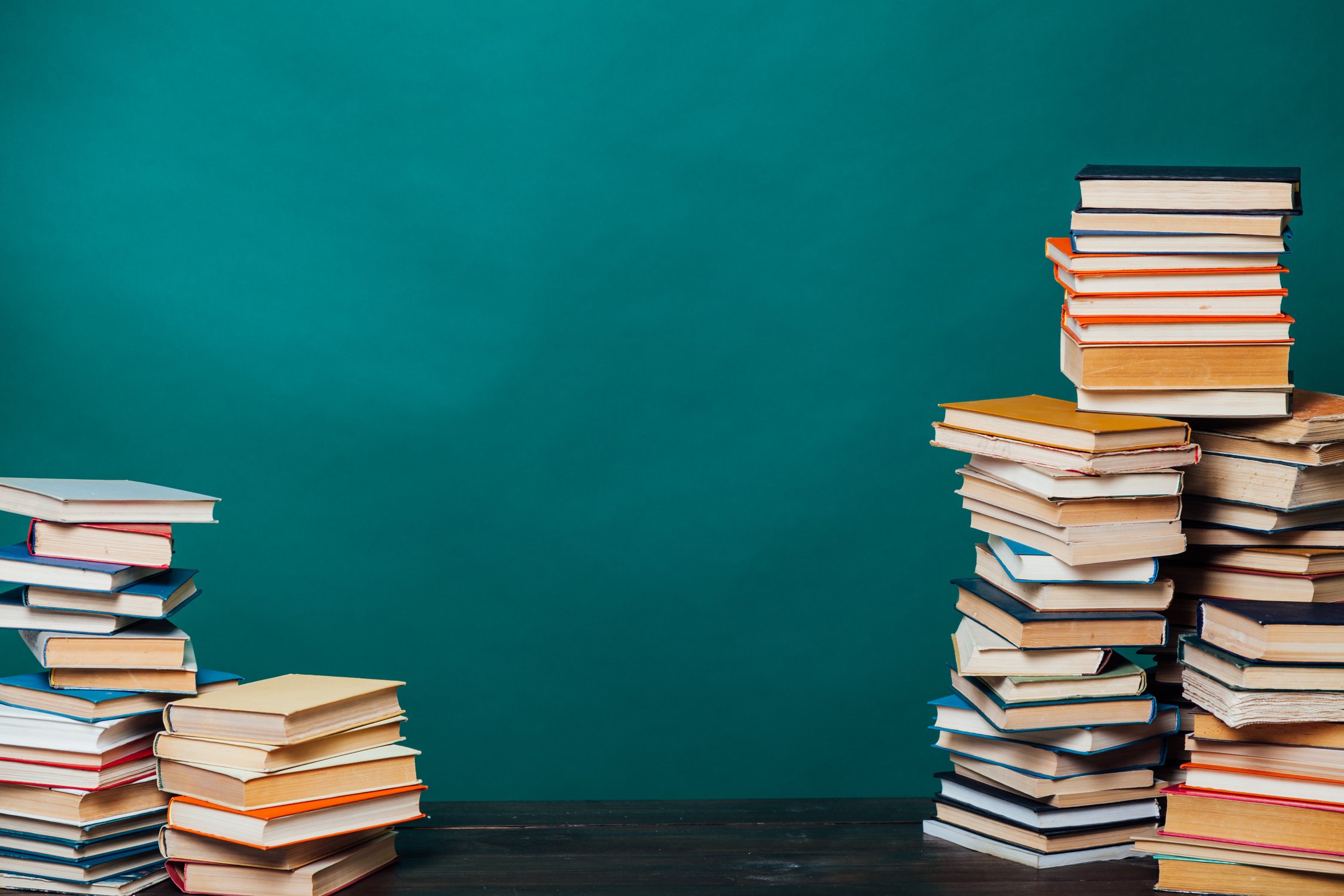 stacks of educational books university library background